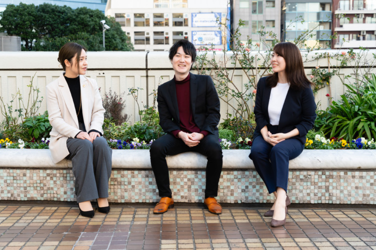 談笑中のアディーレ法律事務所の鈴木康平さんと安田さん、鈴木実乃里さん