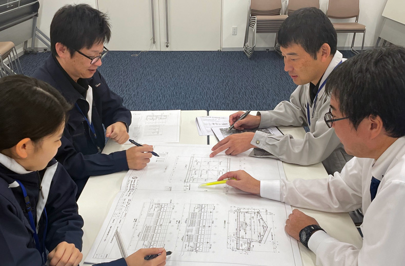 図面を見ながら協議をする、建築住宅課の職員